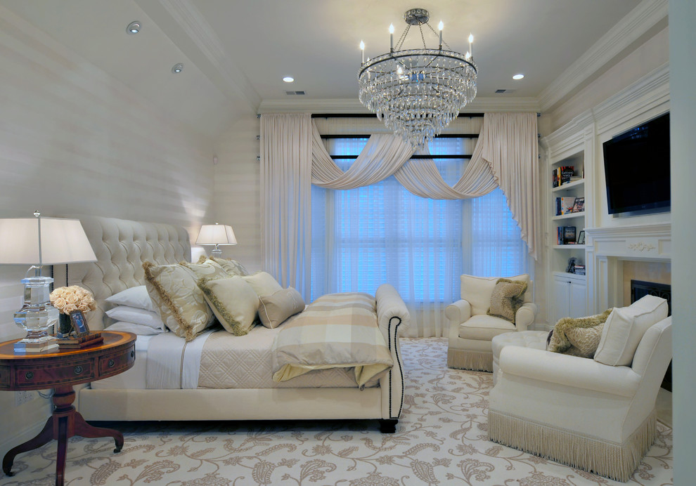 This is an example of a traditional bedroom in Miami with white walls, carpet, a standard fireplace and beige floor.