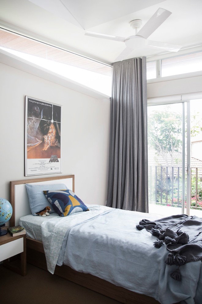 Inspiration for a mid-sized contemporary guest bedroom in Sydney with white walls and carpet.