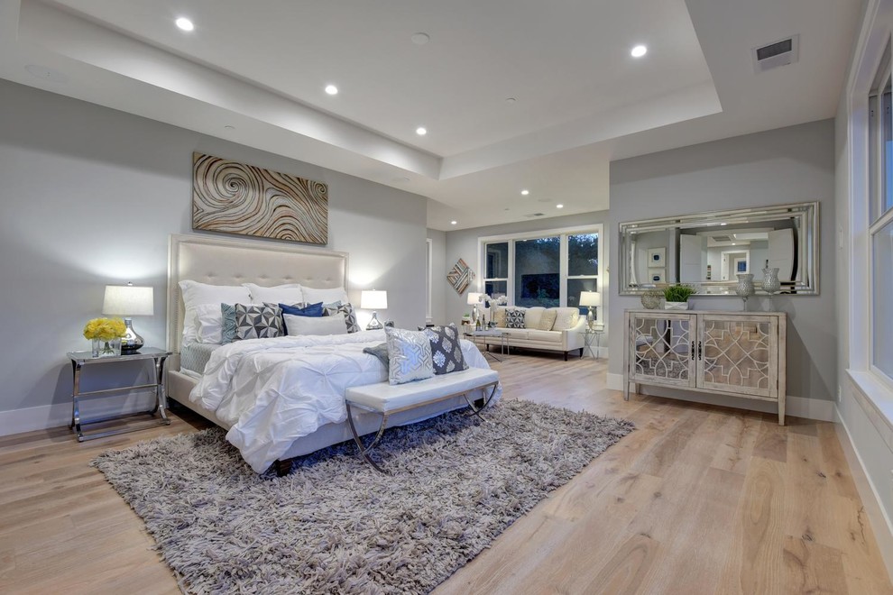Design ideas for a large transitional master bedroom in San Francisco with grey walls, light hardwood floors and white floor.