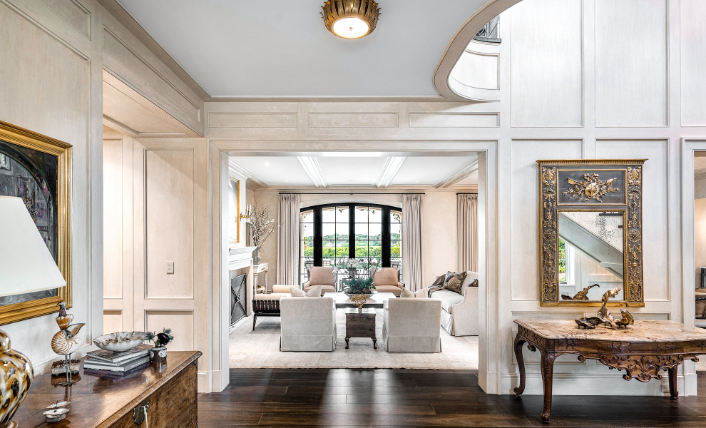 Huge transitional dark wood floor, brown floor and wallpaper foyer photo in Miami with a dark wood front door and beige walls