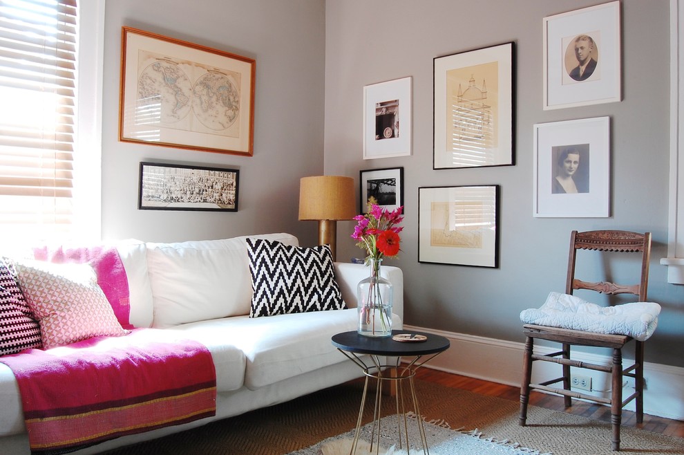 This is an example of an eclectic family room in New York with grey walls.