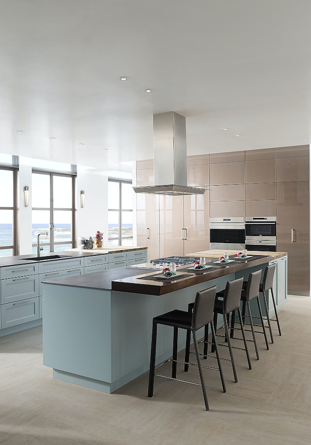This is an example of a large contemporary galley eat-in kitchen in Miami with an undermount sink, shaker cabinets, blue cabinets, soapstone benchtops, stainless steel appliances, porcelain floors, multiple islands and beige floor.