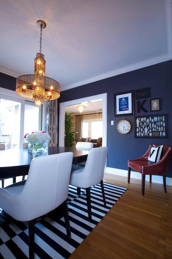 Inspiration for a traditional dining room in Sacramento with black walls and medium hardwood floors.