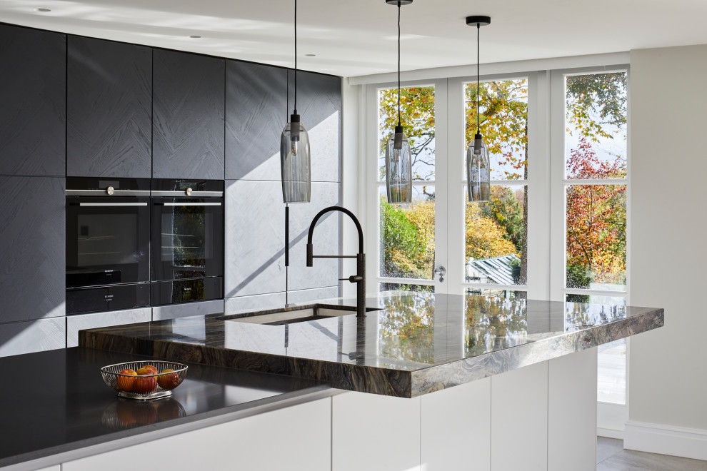 Design ideas for an expansive contemporary single-wall eat-in kitchen in Kent with flat-panel cabinets, dark wood cabinets, multi-coloured splashback, stone slab splashback, stainless steel appliances, porcelain floors, with island, grey floor and multi-coloured benchtop.