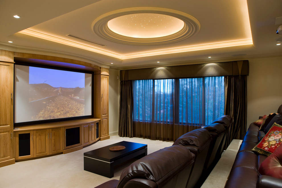 This is an example of a large mediterranean enclosed home theatre in Perth with beige walls, carpet, a projector screen and beige floor.