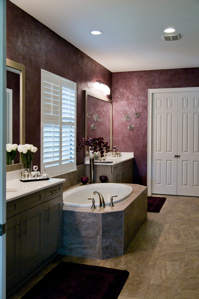 Large transitional master bathroom in Miami with shaker cabinets, grey cabinets, a drop-in tub, an alcove shower, a two-piece toilet, purple walls, ceramic floors, an integrated sink, beige floor and a hinged shower door.