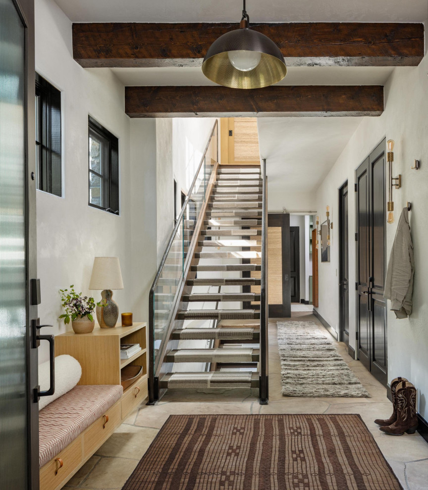 Inspiration for a medium sized modern front door in Denver with white walls, a single front door, a glass front door, exposed beams, vinyl flooring and brown floors.