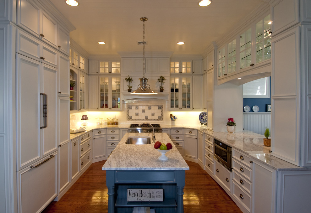 Design ideas for a traditional u-shaped separate kitchen in Orlando with white cabinets and panelled appliances.