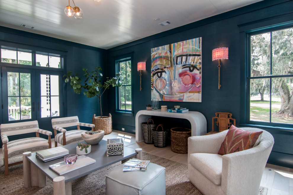 Photo of a transitional living room in Atlanta with blue walls, light hardwood floors, beige floor and wallpaper.
