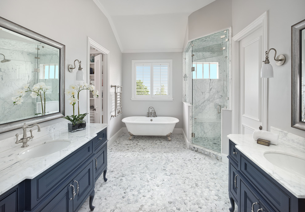 Design ideas for a traditional master bathroom in Dallas with blue cabinets, a claw-foot tub, grey walls, an undermount sink, white floor, white benchtops, a corner shower, a hinged shower door, an enclosed toilet, a double vanity, a built-in vanity, vaulted and beaded inset cabinets.