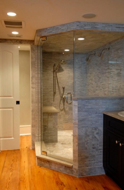 Mid-sized traditional master bathroom in Orlando with recessed-panel cabinets, dark wood cabinets, a corner shower, a two-piece toilet, gray tile, matchstick tile, white walls, medium hardwood floors, a drop-in sink and soapstone benchtops.