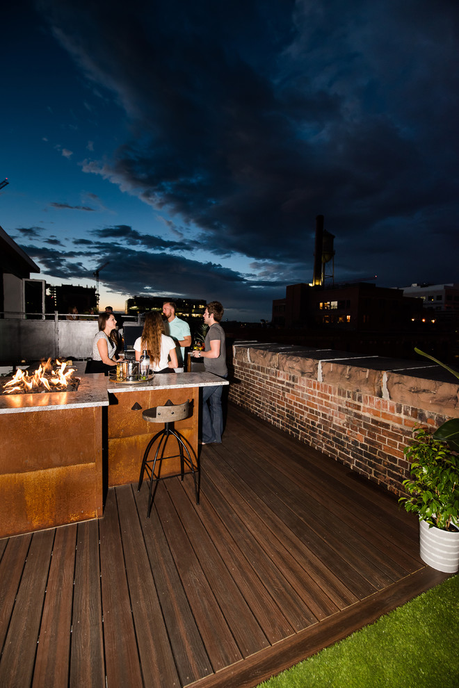 This is an example of a mid-sized modern rooftop deck in Other with a fire feature.