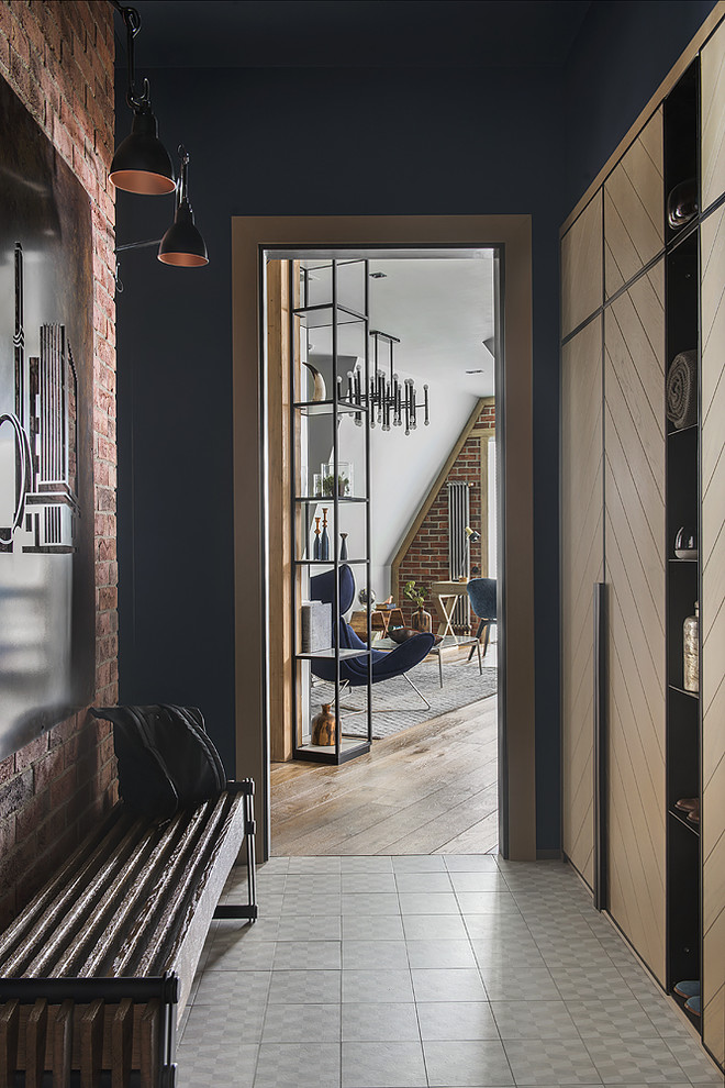 Industrial entryway in Moscow with blue walls, porcelain floors and grey floor.