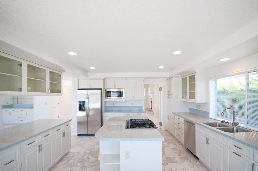 Inspiration for a mid-sized traditional u-shaped eat-in kitchen in Other with a double-bowl sink, shaker cabinets, white cabinets, stainless steel appliances, marble floors and with island.