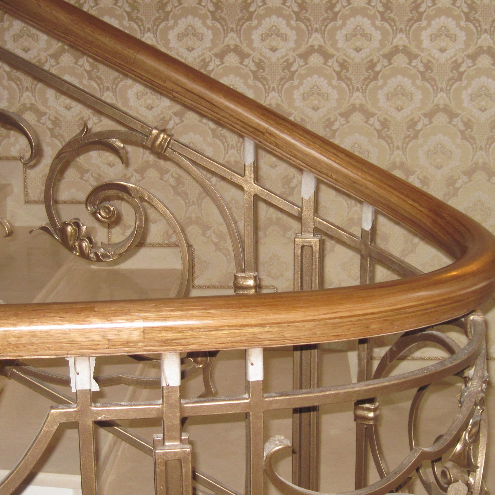 Деревянный гнутый поручень на кованые ограждения лестниц.