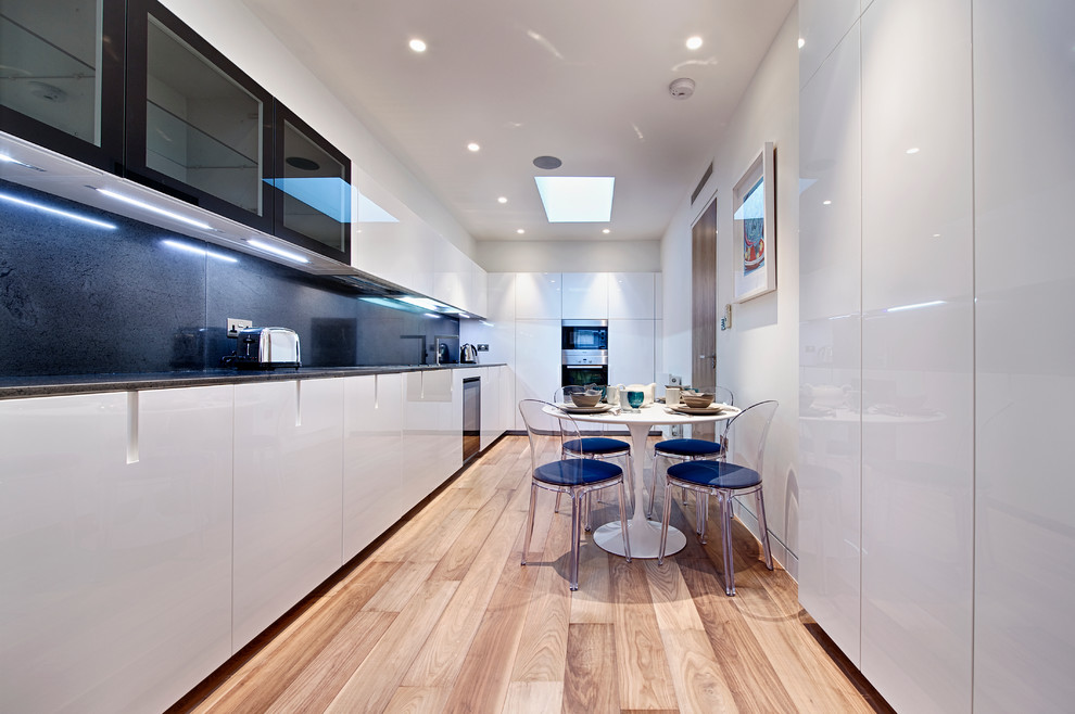 This is an example of a mid-sized contemporary u-shaped kitchen in Surrey.