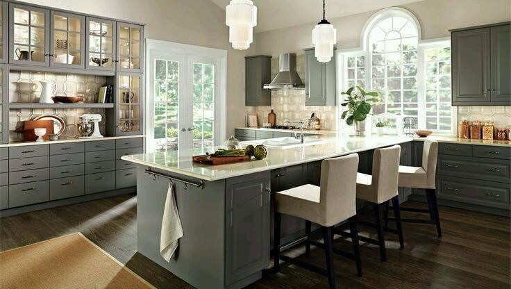 Example of a large transitional l-shaped dark wood floor and brown floor kitchen design in Orange County with an undermount sink, raised-panel cabinets, gray cabinets, granite countertops, beige backsplash, stainless steel appliances and an island