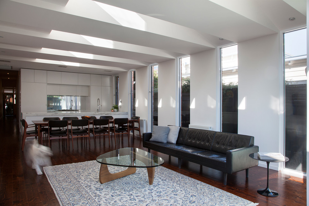 Contemporary living room in Melbourne with white walls and medium hardwood floors.