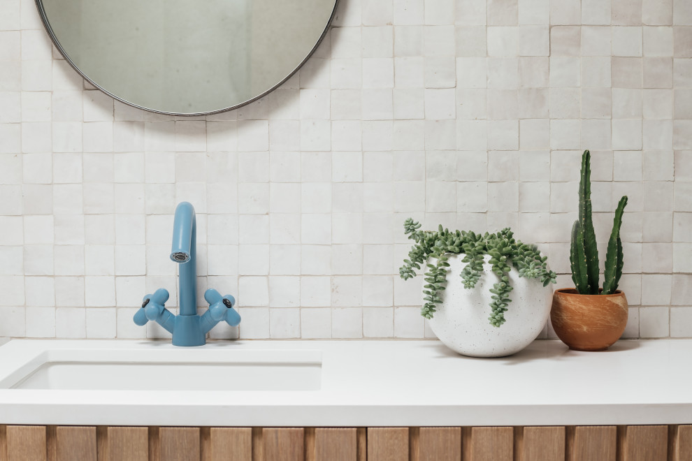 Mid-sized 1960s kids' white tile and terra-cotta tile terrazzo floor, gray floor and double-sink bathroom photo in Salt Lake City with beaded inset cabinets, light wood cabinets, a one-piece toilet, white walls, an integrated sink, quartz countertops, white countertops and a built-in vanity