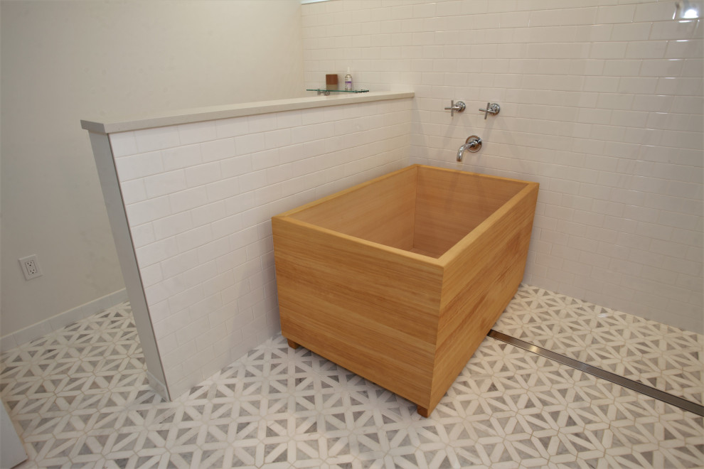 Large transitional bathroom in Seattle with a japanese tub, white tile, subway tile, white walls, porcelain floors and multi-coloured floor.