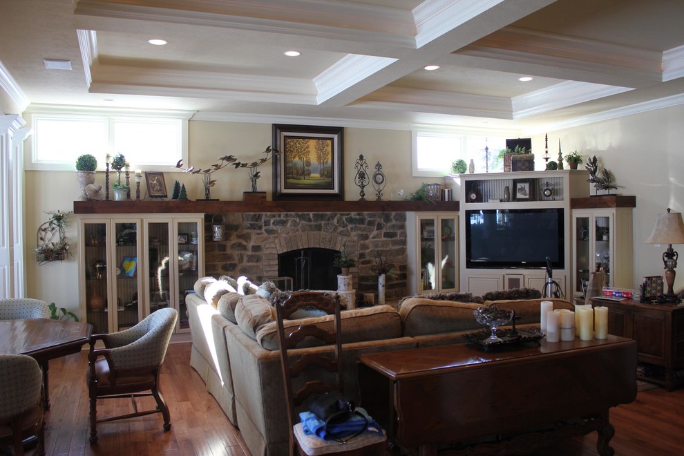 Photo of a mid-sized traditional formal enclosed living room in Indianapolis with beige walls, dark hardwood floors, a standard fireplace, a stone fireplace surround and brown floor.