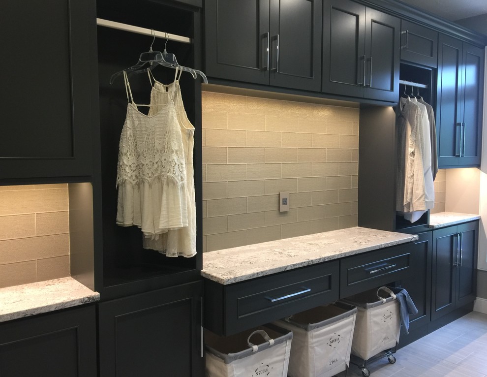 Large l-shaped dedicated laundry room in Chicago with an undermount sink, flat-panel cabinets, grey cabinets, quartz benchtops, grey walls, ceramic floors and a side-by-side washer and dryer.
