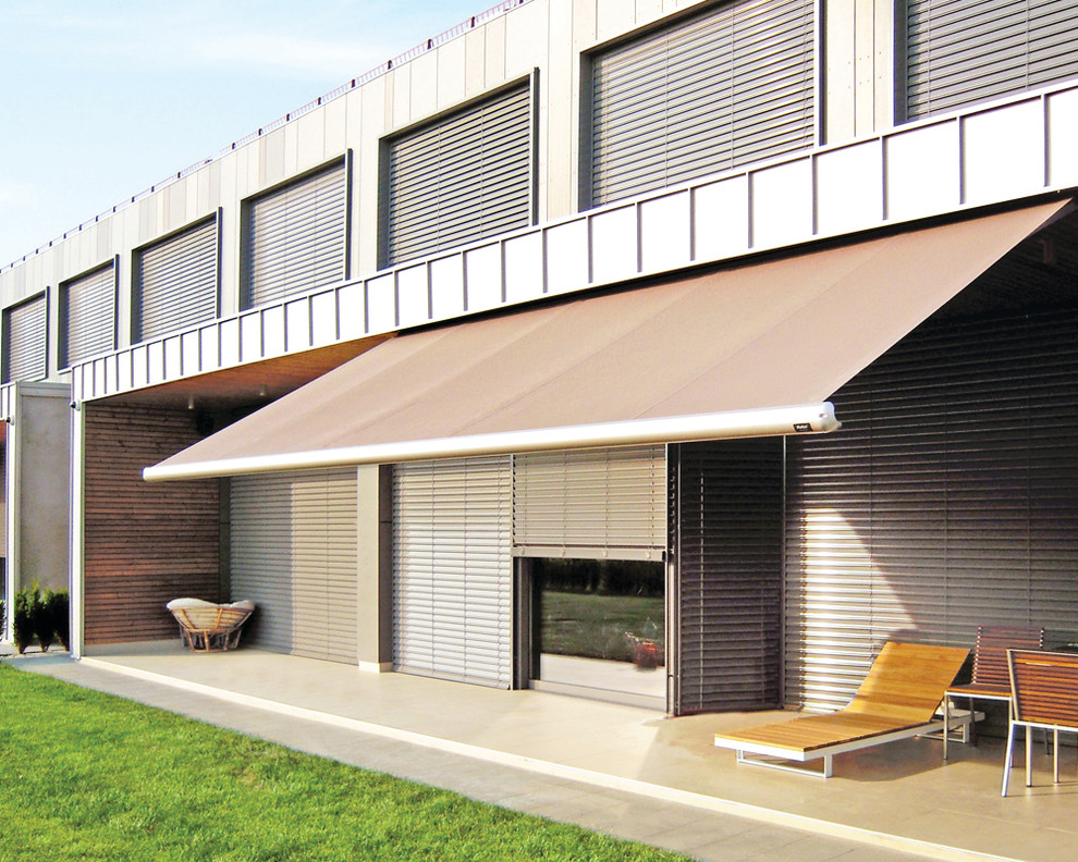 This is an example of a contemporary patio in Sydney with an awning.