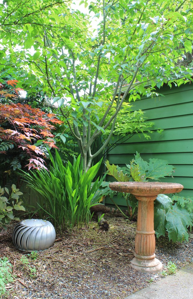 This is an example of an eclectic backyard shaded garden with a vegetable garden.