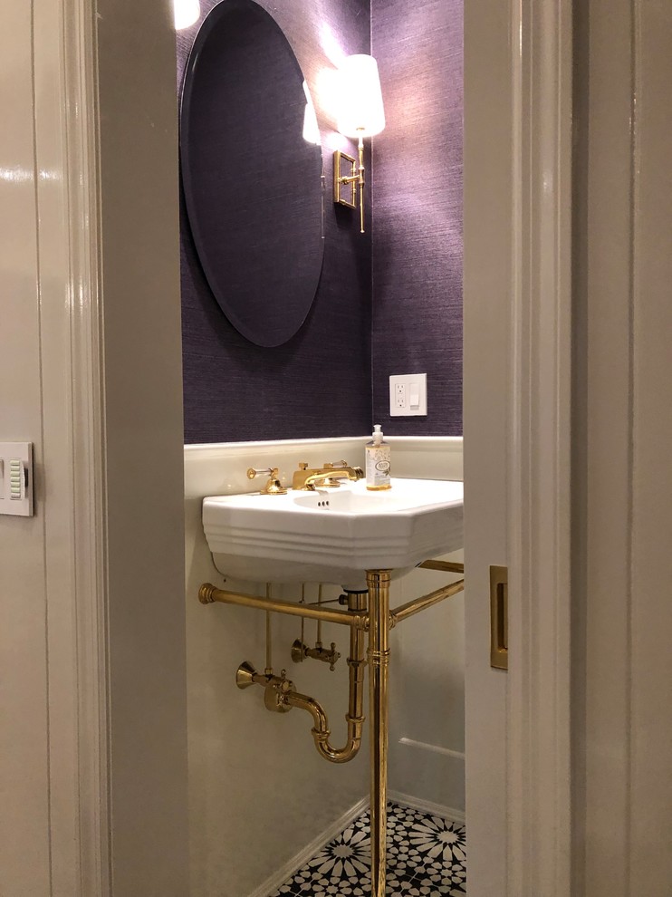 Photo of a small traditional powder room in New York with purple walls, cement tiles, a pedestal sink and black floor.