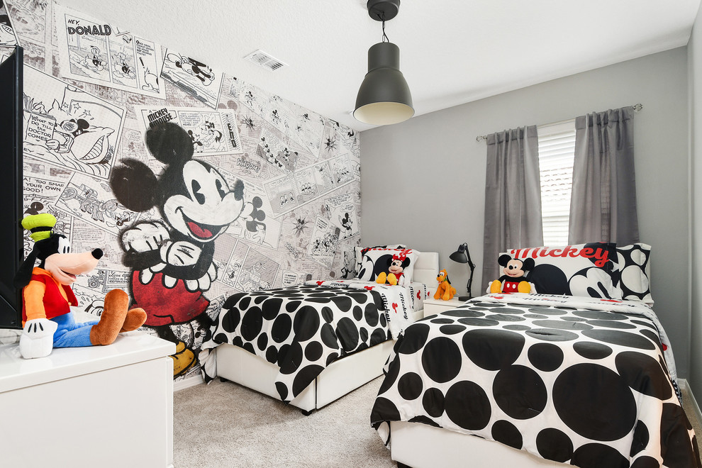 This is an example of a contemporary gender-neutral kids' bedroom for kids 4-10 years old in Orlando with grey walls, carpet and beige floor.