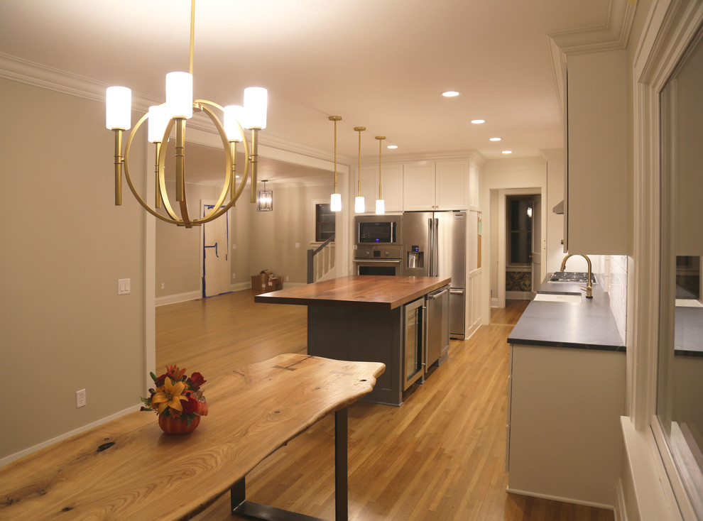Kitchen/dining room combo - mid-sized transitional medium tone wood floor kitchen/dining room combo idea with white walls and no fireplace