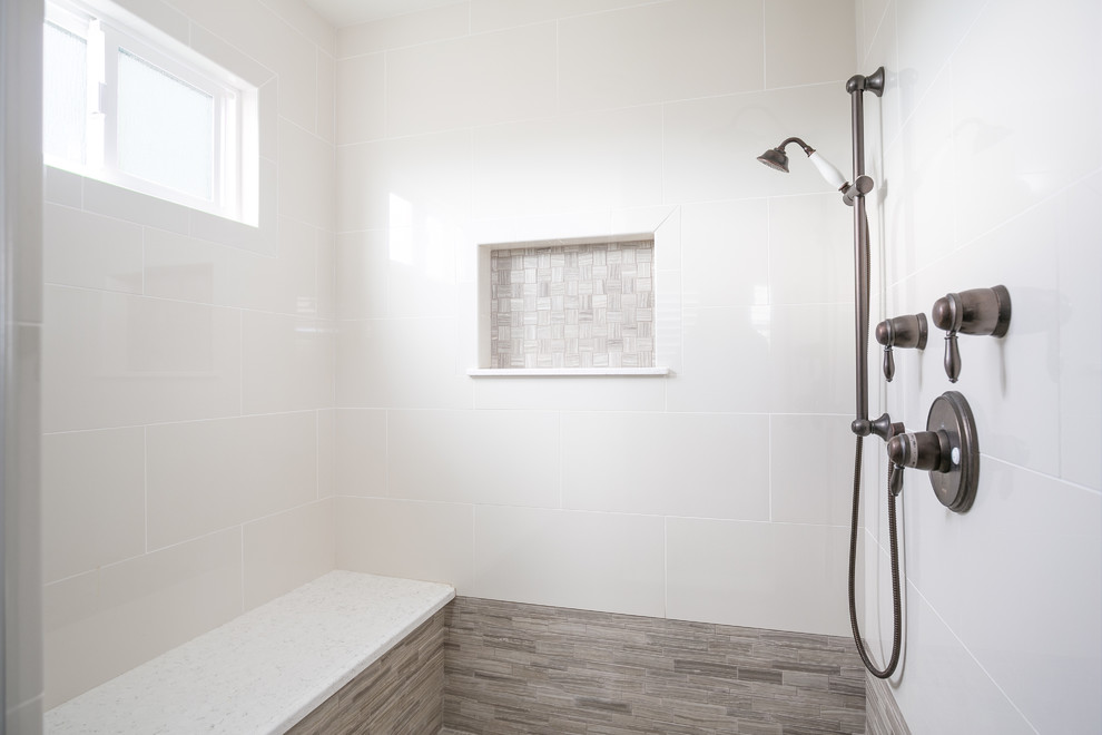 Inspiration for a mid-sized country master bathroom in San Diego with recessed-panel cabinets, a drop-in tub, an alcove shower, gray tile, beige walls, ceramic floors, an undermount sink, engineered quartz benchtops, dark wood cabinets, porcelain tile, white floor and a hinged shower door.
