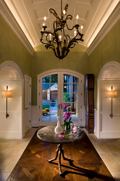 Inspiration for a mid-sized traditional foyer in Miami with green walls, dark hardwood floors, a single front door, brown floor, coffered and decorative wall panelling.