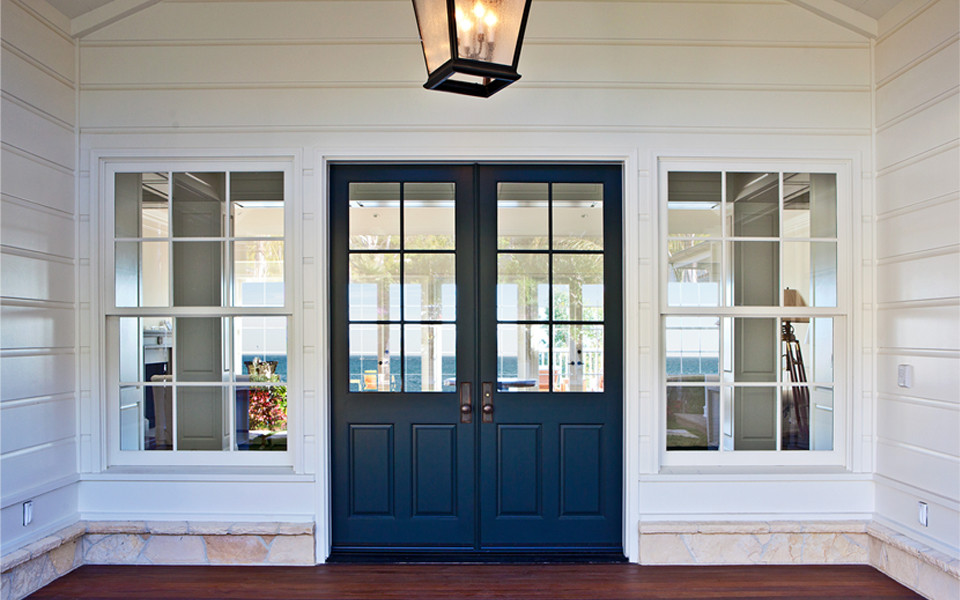 Design ideas for a mid-sized traditional front door in Los Angeles with white walls, dark hardwood floors, a double front door and a blue front door.
