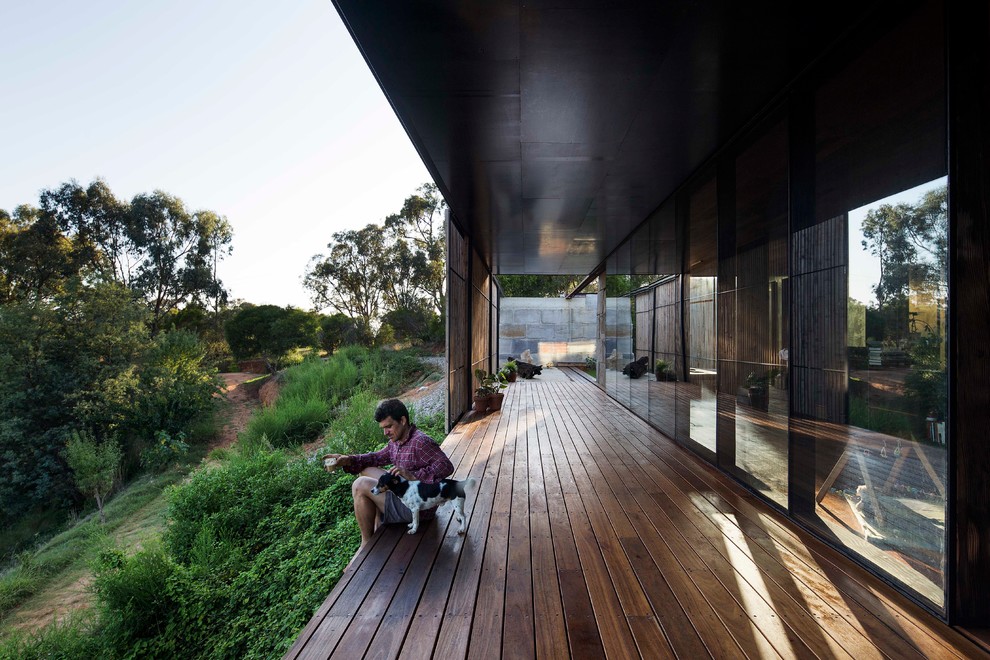 Design ideas for a modern deck in Melbourne with a roof extension.