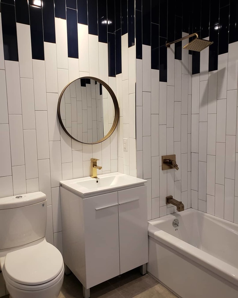 This is an example of a mid-sized contemporary master bathroom in New York with beaded inset cabinets, white cabinets, a drop-in tub, a shower/bathtub combo, a two-piece toilet, black and white tile, ceramic tile, multi-coloured walls, cement tiles, an integrated sink, engineered quartz benchtops, beige floor, an open shower and white benchtops.