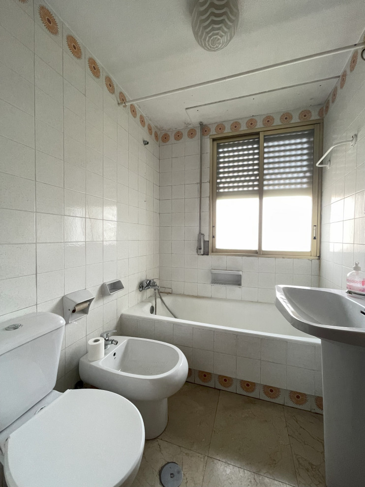 Photo of a medium sized retro ensuite bathroom in Madrid with an alcove bath, a shower/bath combination, a two-piece toilet, white tiles, ceramic tiles, white walls, ceramic flooring, a pedestal sink, beige floors, a shower curtain, a single sink, a built in vanity unit, a drop ceiling and brick walls.