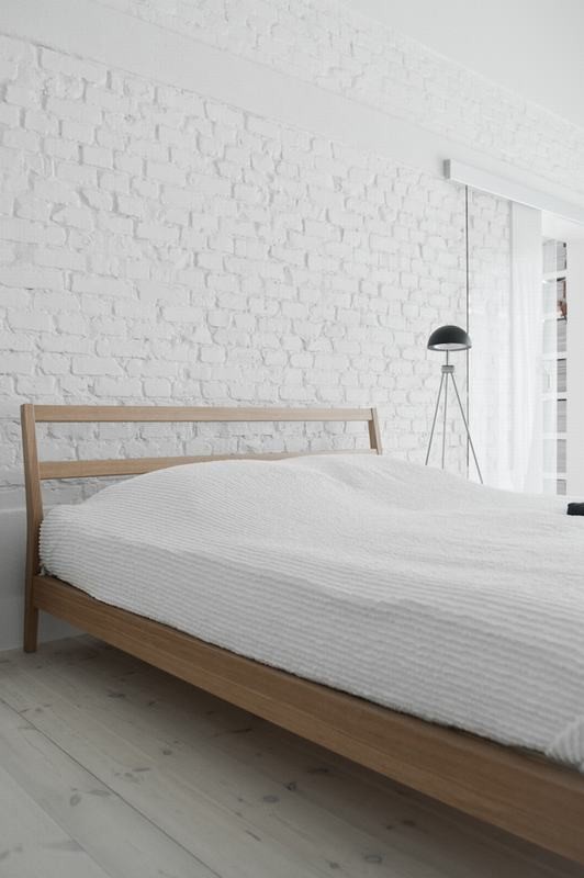 Photo of a mid-sized scandinavian master bedroom in Other with white walls and light hardwood floors.