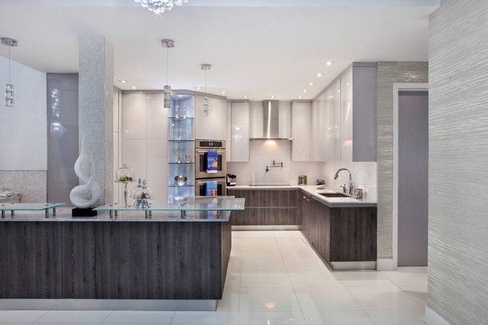 This is an example of an expansive modern l-shaped eat-in kitchen in Miami with a double-bowl sink, flat-panel cabinets, white cabinets, quartz benchtops, white splashback, mosaic tile splashback, stainless steel appliances, marble floors and with island.