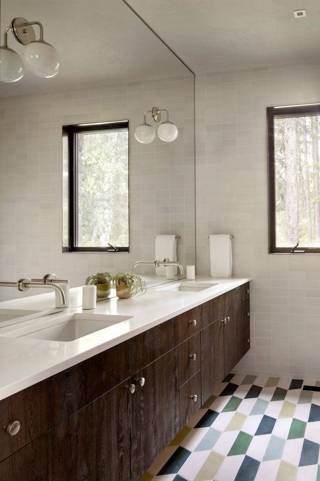 Design ideas for a mid-sized country master bathroom in Other with flat-panel cabinets, medium wood cabinets, solid surface benchtops, white benchtops, white tile, an undermount sink and multi-coloured floor.