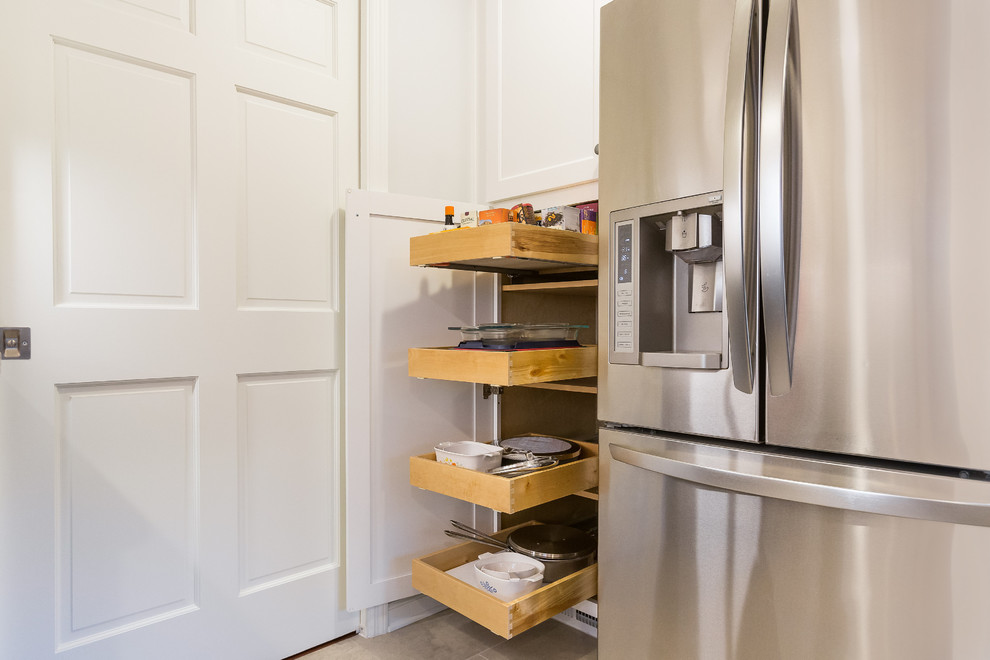Example of a mid-sized transitional u-shaped porcelain tile enclosed kitchen design in Birmingham with a double-bowl sink, shaker cabinets, granite countertops, gray backsplash, ceramic backsplash, stainless steel appliances and no island