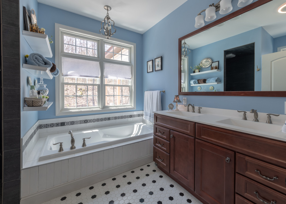 Design ideas for a mid-sized traditional master bathroom in Other with recessed-panel cabinets, dark wood cabinets, a drop-in tub, an alcove shower, blue walls, ceramic floors, an integrated sink, marble benchtops, multi-coloured floor, an open shower and white benchtops.