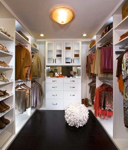 This is an example of a large country gender-neutral walk-in wardrobe in Los Angeles with flat-panel cabinets and white cabinets.