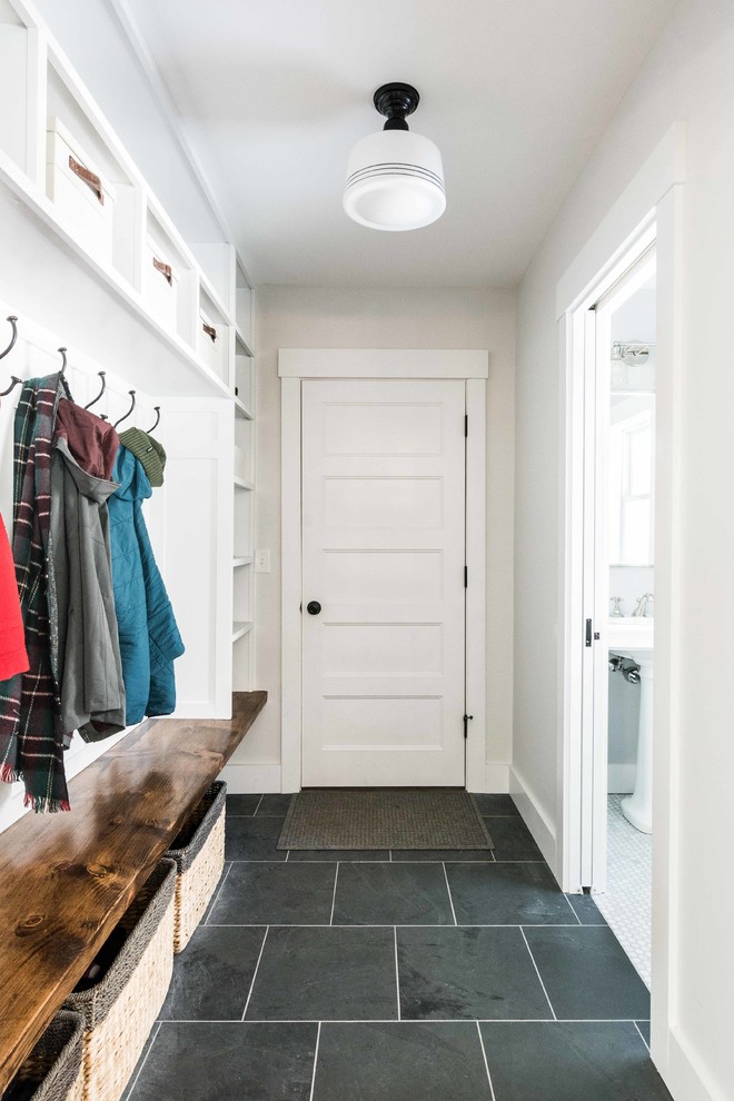 Inspiration for a mid-sized country mudroom in Portland Maine with white walls, slate floors and grey floor.