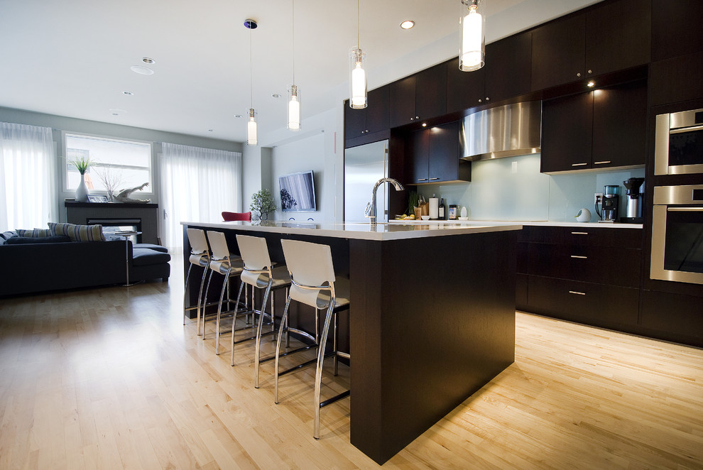 Contemporary open plan kitchen in Calgary with stainless steel appliances.