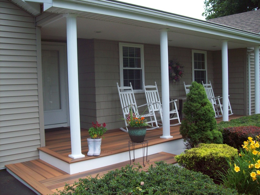 This is an example of a mid-sized traditional front yard verandah in Bridgeport with decking and a roof extension.