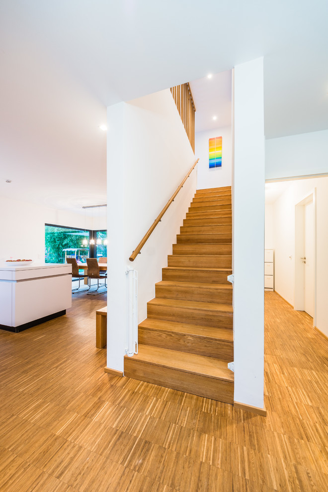 Mid-sized contemporary wood straight staircase in Frankfurt with wood risers.
