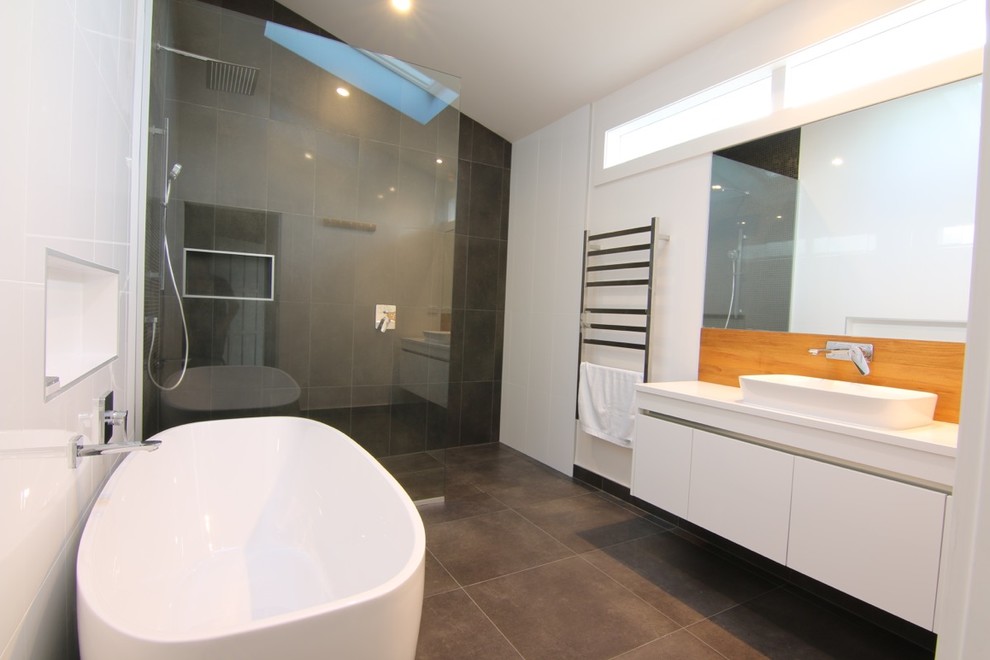 Large modern kids wet room bathroom in Auckland with flat-panel cabinets, white cabinets, a freestanding tub, black and white tile, white walls, ceramic floors, engineered quartz benchtops, an open shower, white benchtops, a single vanity and a floating vanity.