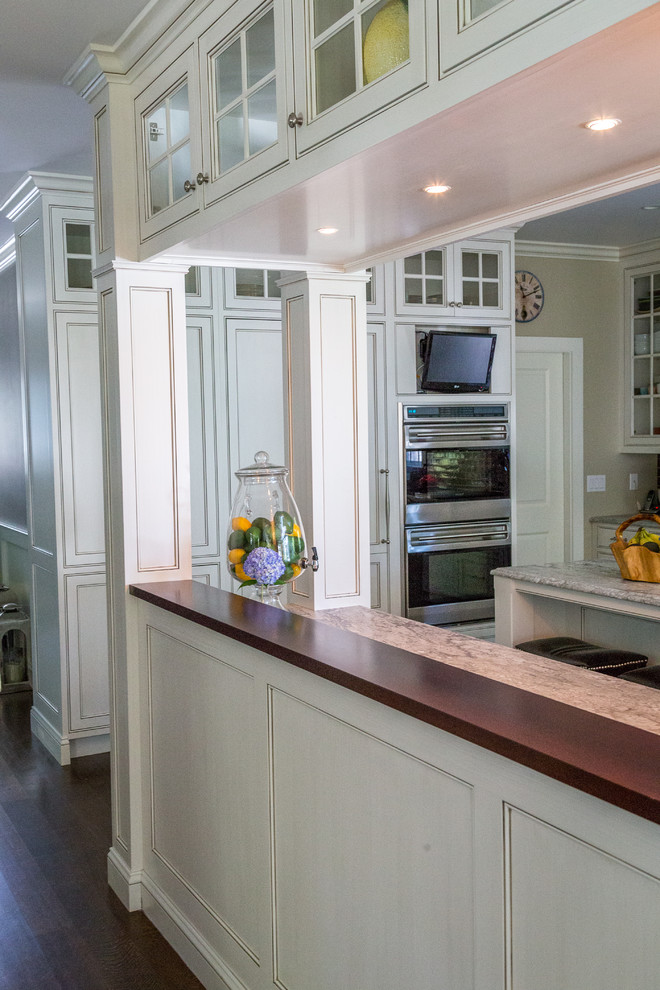 Inspiration for a mid-sized transitional galley dark wood floor kitchen pantry remodel in Bridgeport with recessed-panel cabinets, gray cabinets, granite countertops, gray backsplash, stainless steel appliances, two islands, a farmhouse sink and subway tile backsplash