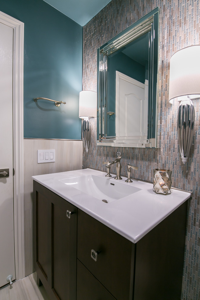 Design ideas for a mid-sized contemporary powder room in San Francisco with furniture-like cabinets, dark wood cabinets, a two-piece toilet, multi-coloured tile, mosaic tile, blue walls, porcelain floors, an integrated sink, engineered quartz benchtops, grey floor and white benchtops.